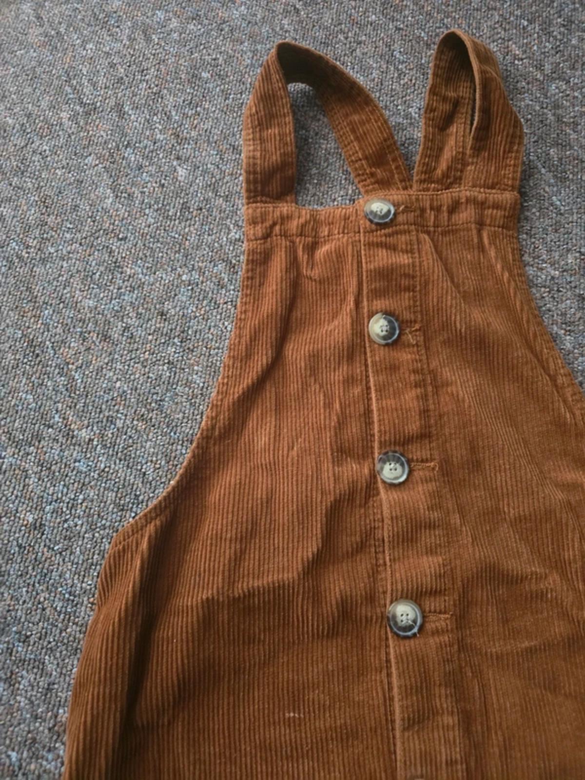 Corduroy brown/tan pinafore dress with button up front and pockets, size 10