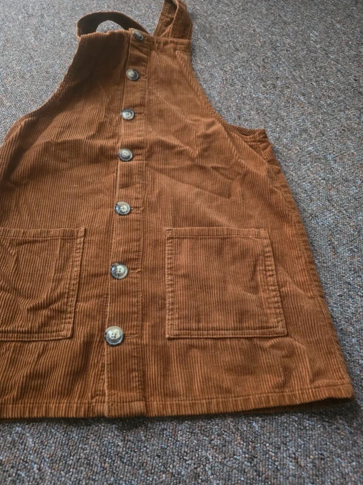 Corduroy brown/tan pinafore dress with button up front and pockets, size 10